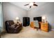 Home office featuring a cozy recliner, desk, safe, and neutral carpet flooring, ideal for remote work or study at 3545 Inverness Blvd, Carmel, IN 46032