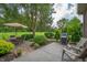 Paved patio featuring a gas grill, dining set, seating, and lush, green yard at 3545 Inverness Blvd, Carmel, IN 46032