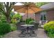 Outdoor patio featuring an umbrella-shaded dining table with chairs surrounded by greenery at 3545 Inverness Blvd, Carmel, IN 46032