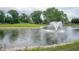 Scenic water feature with fountain surrounded by lush green landscaping at 3545 Inverness Blvd, Carmel, IN 46032