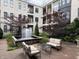 Inviting courtyard with a decorative water fountain, lovely landscaping, and comfortable outdoor seating at 355 E Ohio St # 211, Indianapolis, IN 46204