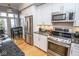 Modern kitchen with stainless steel appliances, granite counters, and hardwood floors at 355 E Ohio St # 211, Indianapolis, IN 46204