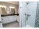 Bright bathroom featuring dual sinks, granite countertops, and a glass-enclosed shower at 355 E Ohio St # 211, Indianapolis, IN 46204