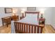 Comfortable bedroom with hardwood floors, featuring a wooden bed frame, desk, and ample natural light at 355 E Ohio St # 211, Indianapolis, IN 46204