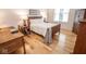 Well-lit bedroom with wood furnishings, offering a relaxing atmosphere with a comfortable bed and study area at 355 E Ohio St # 211, Indianapolis, IN 46204