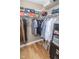 Organized walk-in closet featuring built-in shelving, shoe storage, and hanging space for clothing at 355 E Ohio St # 211, Indianapolis, IN 46204