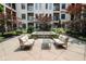 Inviting courtyard featuring outdoor seating, a charming water feature, and mature trees at 355 E Ohio St # 211, Indianapolis, IN 46204