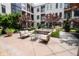 Secluded courtyard with seating around a decorative water feature, enhanced by lush landscaping and architectural accents at 355 E Ohio St # 211, Indianapolis, IN 46204