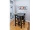 Cozy dining area with modern black table and chairs, located near a bright window and door to the outside at 355 E Ohio St # 211, Indianapolis, IN 46204