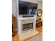 Elegant fireplace with a mounted TV above, providing a focal point in the living area for warmth and entertainment at 355 E Ohio St # 211, Indianapolis, IN 46204