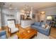Comfortable open-concept living space featuring a modern kitchen, wood floors, and a cozy blue sofa at 355 E Ohio St # 211, Indianapolis, IN 46204