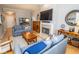 Inviting living room with fireplace, TV, and plush blue sofas, perfect for relaxation and entertaining at 355 E Ohio St # 211, Indianapolis, IN 46204