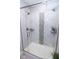 Walk-in shower featuring frameless glass doors, tiled walls, and dual shower heads at 355 E Ohio St # 211, Indianapolis, IN 46204