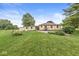 Beautiful backyard with lush green grass, mature trees, and a detached garage at 4010 S Bazil Ave, Indianapolis, IN 46239