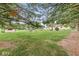 Expansive backyard showcasing mature trees, a play set, and a serene outdoor space at 4010 S Bazil Ave, Indianapolis, IN 46239