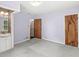 This bedroom features neutral carpet, a light fixture, and an ensuite bathroom with mosaic details at 4010 S Bazil Ave, Indianapolis, IN 46239