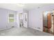 Inviting bedroom featuring plush carpet, neutral decor, and a convenient adjacent bathroom at 4010 S Bazil Ave, Indianapolis, IN 46239