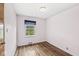 Bedroom features hardwood floors and a window with a view of the outdoors at 4010 S Bazil Ave, Indianapolis, IN 46239