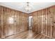 This dining room features wood paneling, hardwood floors, and an ornate chandelier at 4010 S Bazil Ave, Indianapolis, IN 46239