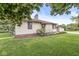 Quaint home featuring well-maintained landscaping, a cozy porch, and a classic brick chimney at 4010 S Bazil Ave, Indianapolis, IN 46239