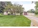Charming ranch-style home featuring a well-manicured lawn, mature tree, and a convenient attached garage at 4010 S Bazil Ave, Indianapolis, IN 46239