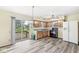 Bright kitchen with wooden cabinets, modern appliances, and sliding glass doors to the backyard at 4010 S Bazil Ave, Indianapolis, IN 46239