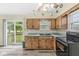 Functional kitchen featuring wooden cabinets, ample counter space, and access to an outdoor deck at 4010 S Bazil Ave, Indianapolis, IN 46239