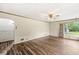 Spacious living room featuring hardwood floors, neutral walls, and large windows for natural light at 4010 S Bazil Ave, Indianapolis, IN 46239