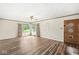 Bright living room with hardwood floors, large windows, and a classic front door at 4010 S Bazil Ave, Indianapolis, IN 46239