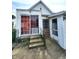 Home exterior featuring a cement patio, fenced yard, and stairs to enter the home at 408 W 4Th St, Anderson, IN 46016