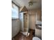 Bathroom featuring tile, a shower stall, and a white vanity with a granite top at 408 W 4Th St, Anderson, IN 46016