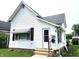Charming white single Gathering home with a well-maintained lawn and an inviting front entrance at 408 W 4Th St, Anderson, IN 46016