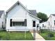 Charming white single Gathering home with a well-maintained lawn and an inviting front entrance at 408 W 4Th St, Anderson, IN 46016