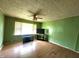 Inviting living room featuring green walls, wood-like flooring, and a ceiling fan at 408 W 4Th St, Anderson, IN 46016