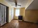 Bedroom featuring yellow walls, an overhead fan, tile floors, and a curtained doorway at 408 W 4Th St, Anderson, IN 46016