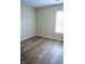 Empty bedroom with wood-look flooring, neutral walls, and a window at 4114 Dunedin Ct, Noblesville, IN 46062