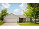 Charming single-story home featuring a two-car garage, brick facade, and well-manicured lawn at 4114 Dunedin Ct, Noblesville, IN 46062