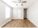 Bedroom with hard wood floors, a ceiling fan and a large sunny window at 413 Youngs Creek Ct, Franklin, IN 46131