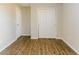 Empty bedroom with wood floors, neutral walls, and a closet at 413 Youngs Creek Ct, Franklin, IN 46131