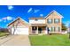 Charming two-story brick home with a well-maintained lawn and attached two-car garage at 413 Youngs Creek Ct, Franklin, IN 46131