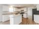 Modern kitchen with white cabinets, granite countertops, and stainless steel appliances at 413 Youngs Creek Ct, Franklin, IN 46131