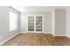 Well-lit living room with hardwood floors and glass doors leading to the stairway at 413 Youngs Creek Ct, Franklin, IN 46131