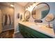 Bathroom with double sinks, round mirrors, and unique accents, blending style with functionality at 4238 Victory Ct, Indianapolis, IN 46203