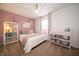Cozy bedroom decorated with pink accents, including a plush blanket, wall decor, and charming pink furniture at 4238 Victory Ct, Indianapolis, IN 46203