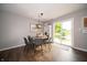 Bright dining area with a wood table, modern light fixture, and sliding glass doors with a backyard view at 4238 Victory Ct, Indianapolis, IN 46203