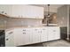 Bright kitchen featuring white cabinets, granite countertops, and stainless steel appliances, offering a modern and clean aesthetic at 4238 Victory Ct, Indianapolis, IN 46203