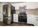 Modern kitchen featuring stainless steel appliances and white cabinetry at 4238 Victory Ct, Indianapolis, IN 46203