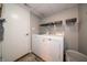 Well-lit laundry room equipped with modern washing machines and ample storage space for convenience at 4238 Victory Ct, Indianapolis, IN 46203