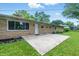 View of the backyard with a concrete patio and manicured lawn at 5205 Staughton Dr, Indianapolis, IN 46226