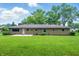 Expansive backyard view showcasing the lawn and exterior of the home at 5205 Staughton Dr, Indianapolis, IN 46226